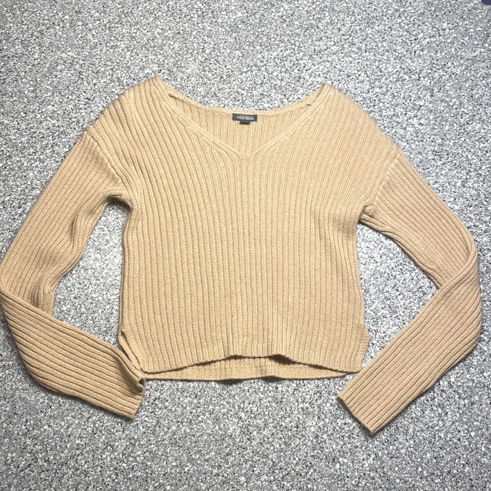 This sweater is a very beautiful creamy brownish color.